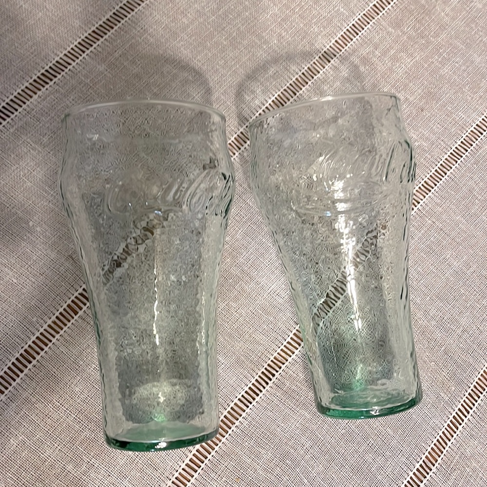 Coca-Cola glasses in green, set of two with different logos on each side.